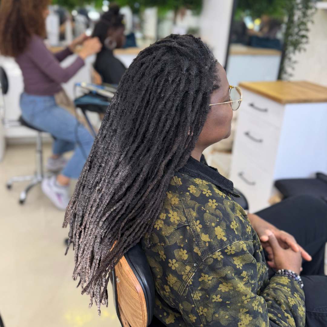 Long flowing mature locs styled down showing length and shine — DES Curl Spa locs service Vancouver BC