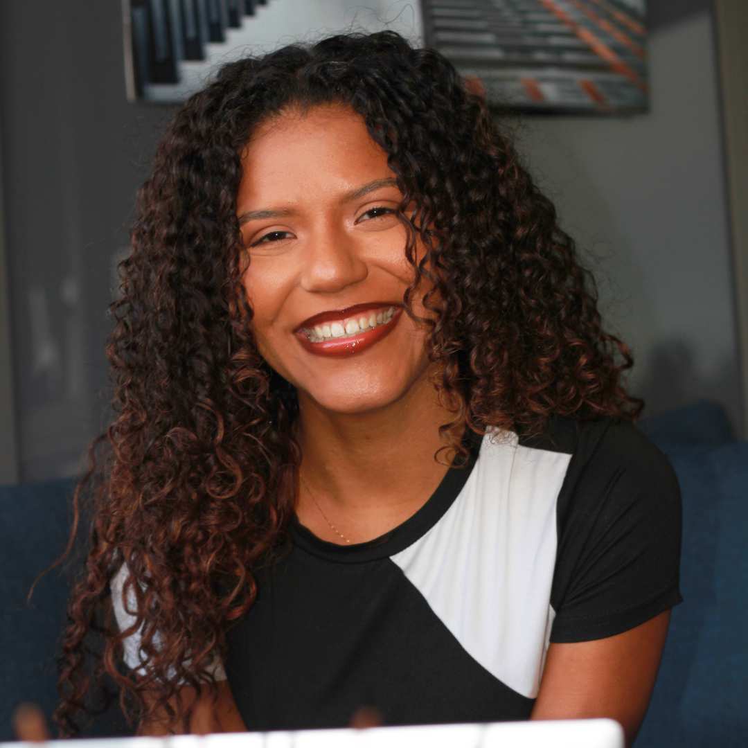 Curly hair client smiling with fresh curly cut by Vancouver stylist Laura
