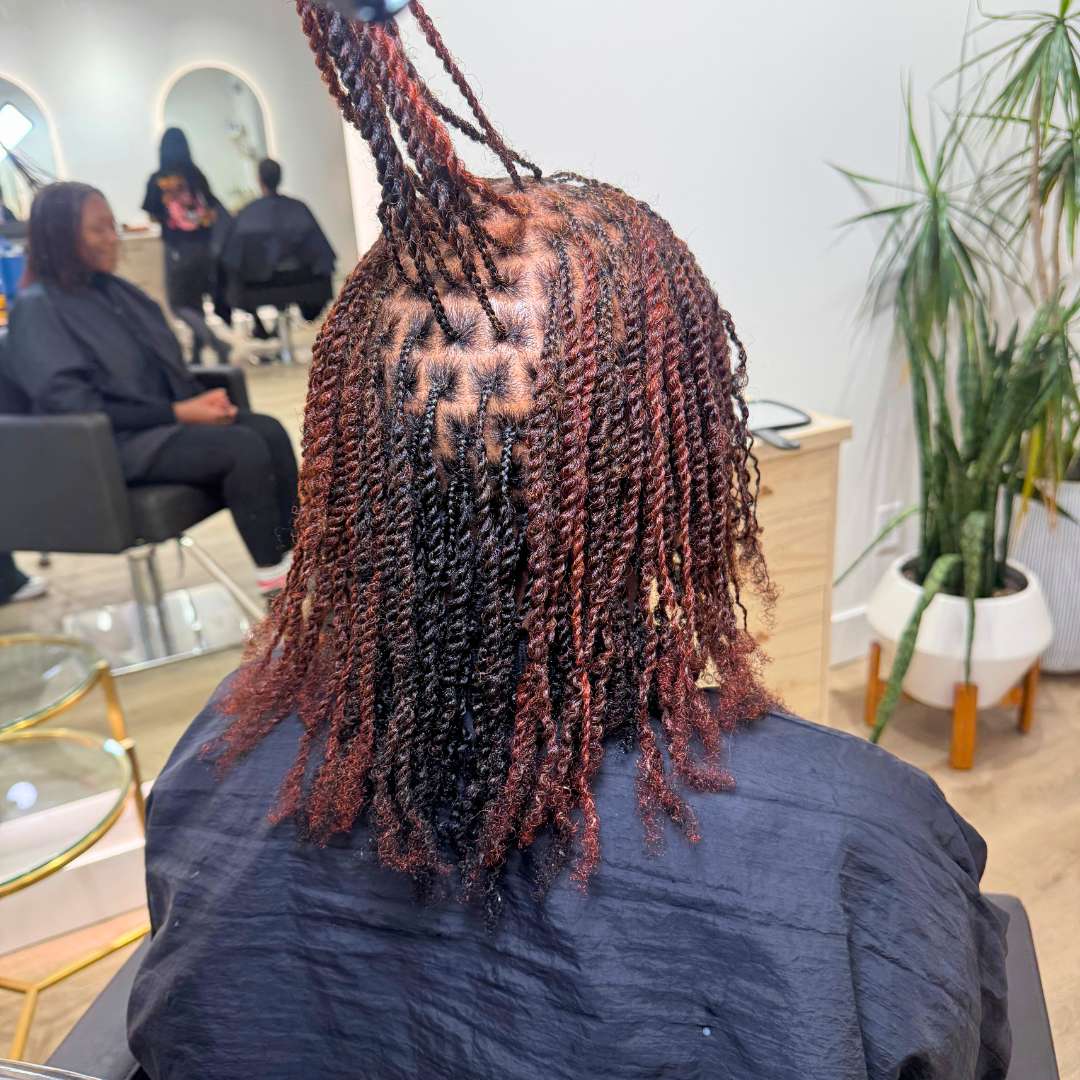 Client with a fresh silk press, smooth straight hair blended with body and shine, styled at the salon.