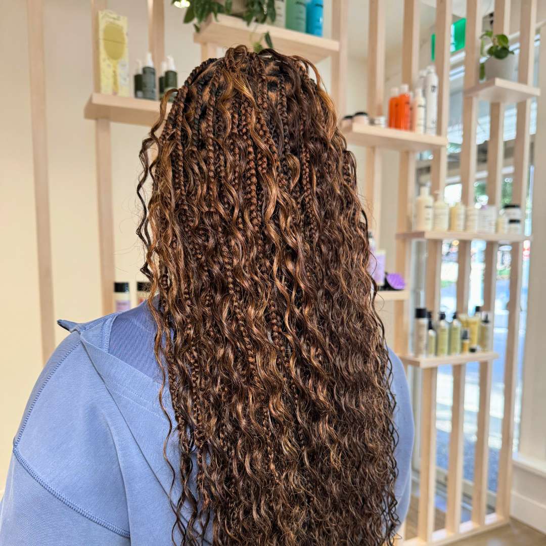Close-up of defined spiral curls after silk press treatment—healthy, smooth, and frizz‑free from curl care specialists
