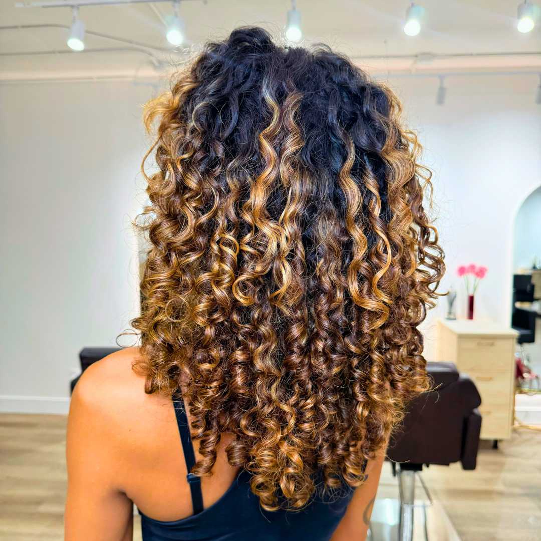 Luscious curly hair styled into a voluminous shape with bounce and shine