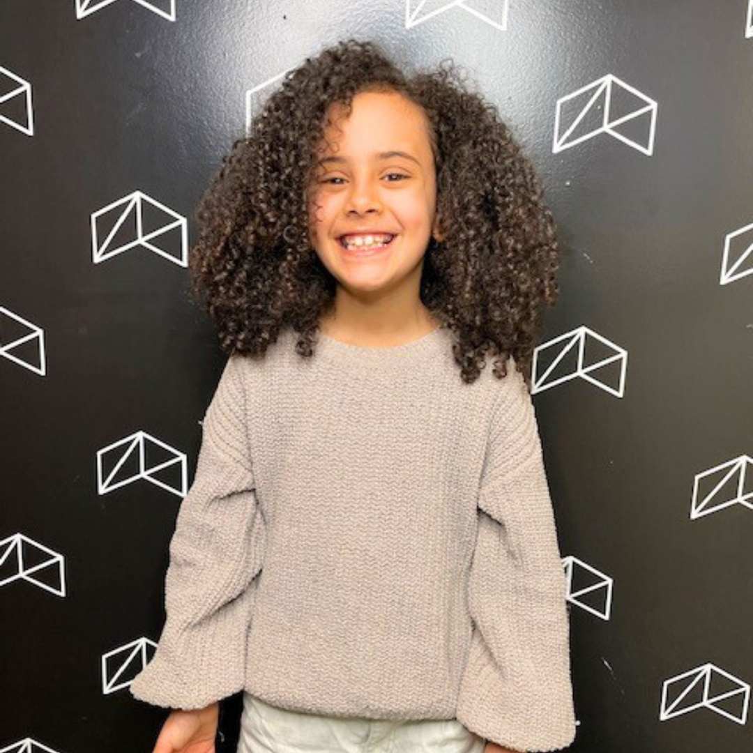 Curly hair for kids styled with soft, bouncy curls and natural shape