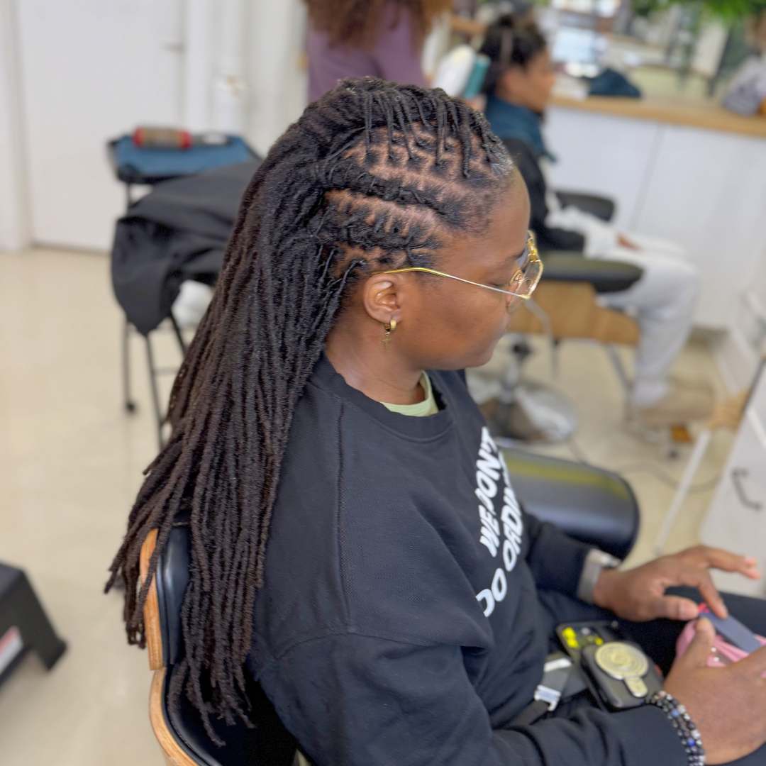 Long locs styled in a sleek half-up ponytail with flat twisted crown — DES Curl Spa loc styling Vancouver