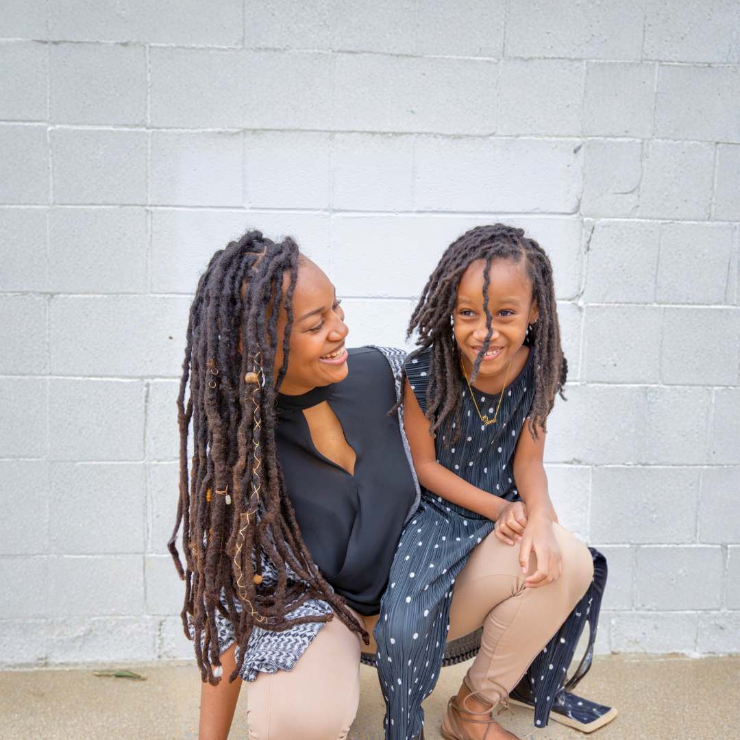 Mother and daughter with long healthy locs hairstyles smiling together — DES Curl Spa Vancouver locs services